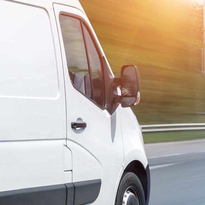 White modern delivery small shipment cargo courier van moving fast on motorway road to city urban suburb. Busines distribution and logistics express service. Mini bus driving on highway day. banner